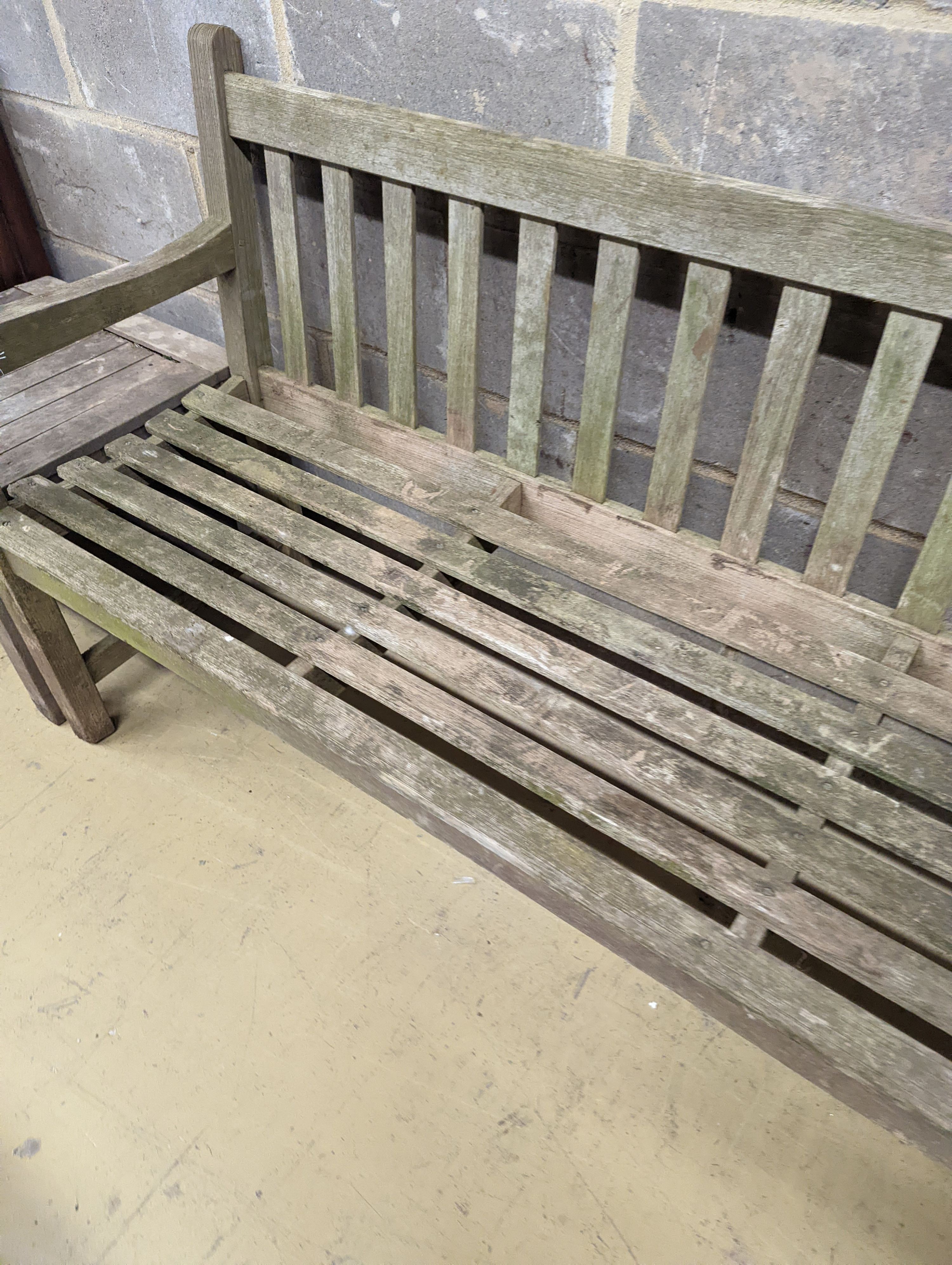 A weathered teak garden bench, length 153cm, depth 50cm, height 79cm and a low square table